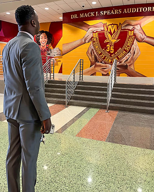 A former student looks at the walls in McDonogh 35 